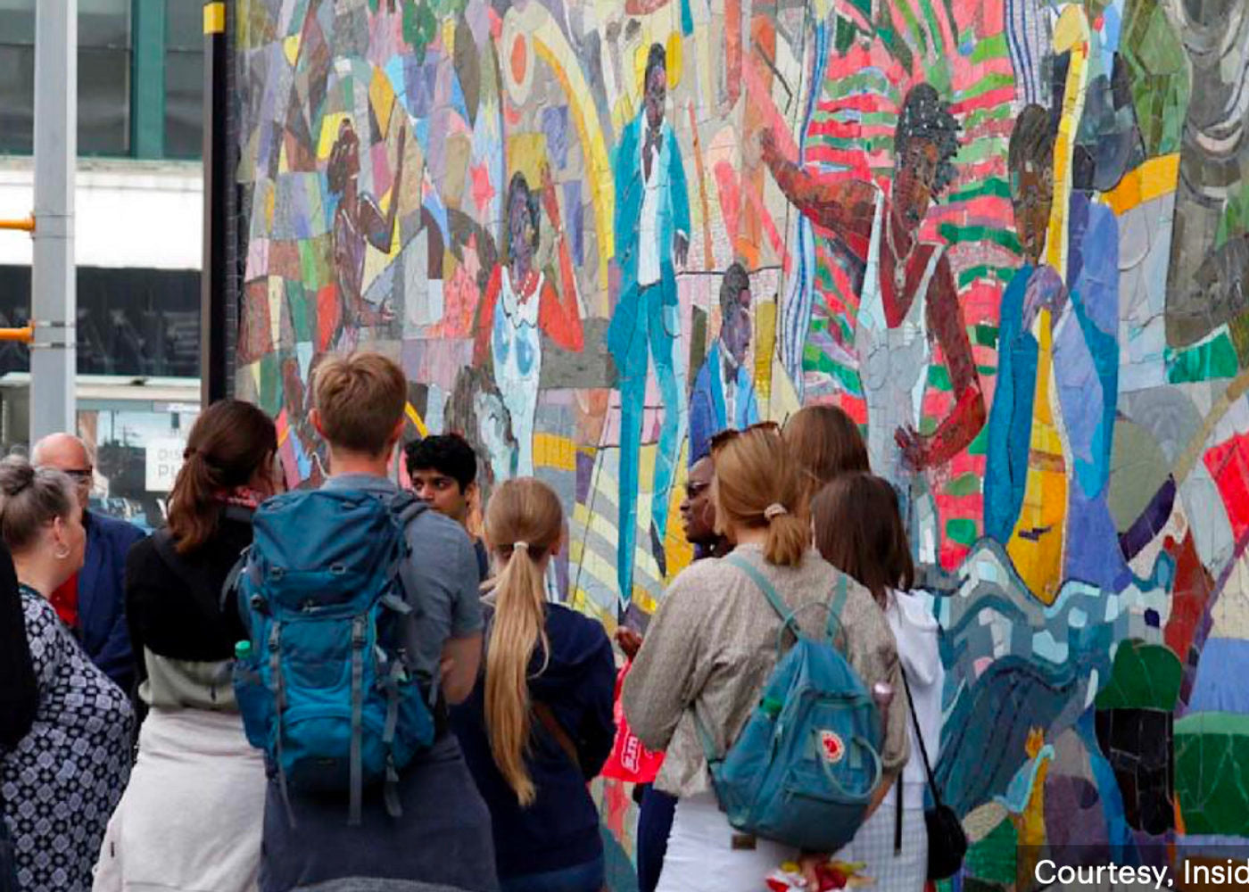 Students looking at a mural